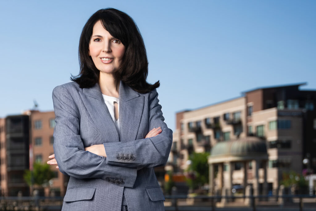 professional portrait of a female with brown hair wearing business attire looking confident and powerful elite headshots chicago in landscape